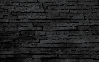 black brick wall background, dark stone texture.  