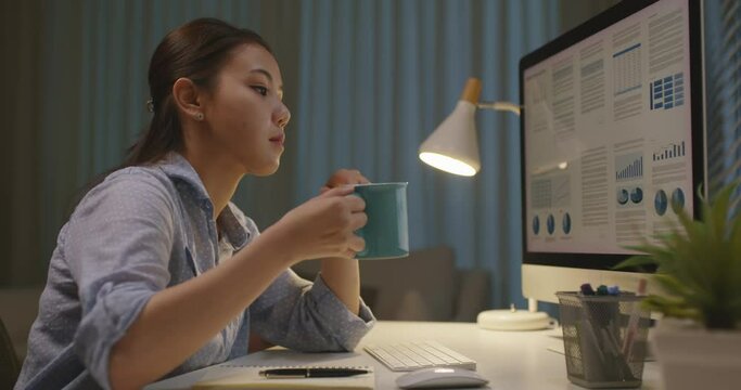 Asia people young woman study hard overnight bored remote learn online read data tired busy sit at home office desk workplace drink energy tea coffee cup thinking worry in job tough stress workforce.