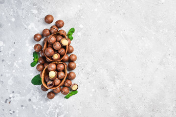 Macadamia nut. On a stone background. Top peregdyad. Free space for text.
