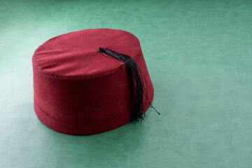 turk fez hat on green leather