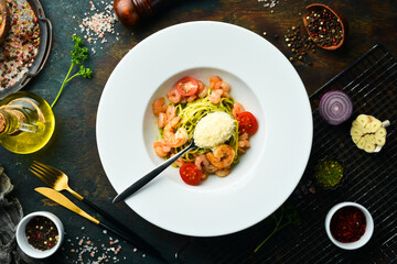 Pasta with shrimp, cheese and pesto sauce. Italian cuisine. Menu. Top view.