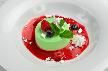 Dessert. Mint panna cotta with ice cream on a plate. Top view.
