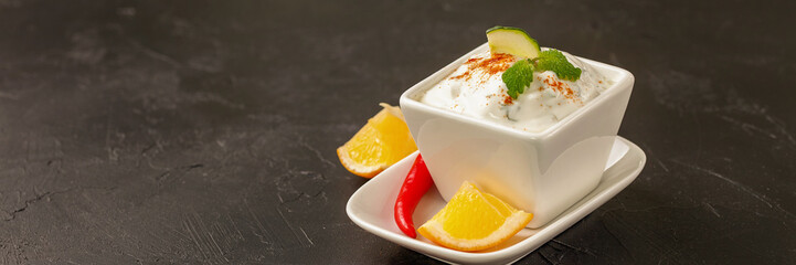 Tzatziki sauce in a  sauce-boat. Ingredients for a dzadziki. Turkish dish cacik. Selective focus. Copy space