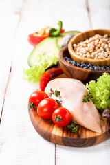 Raw chicken and fresh vegetables on a table. Healthy food. Selective focus. Copy space