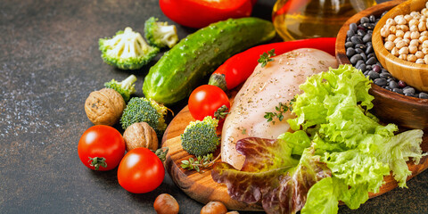 Raw chicken and fresh vegetables on a table. Healthy food. Selective focus. Copy space