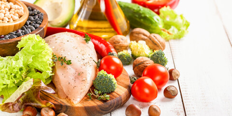 Raw chicken and fresh vegetables on a table. Healthy food. Selective focus. Copy space