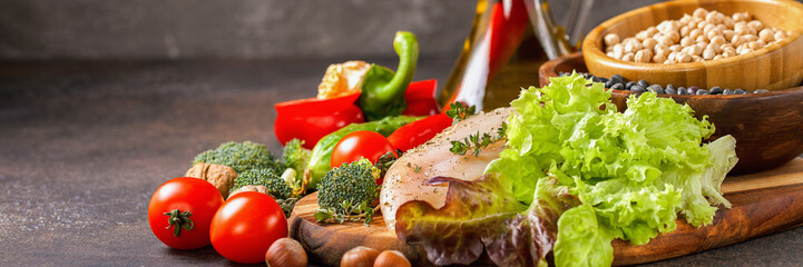 Raw chicken and fresh vegetables on a table. Healthy food. Selective focus. Copy space