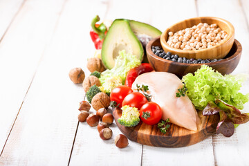 Raw chicken and fresh vegetables on a table. Healthy food. Selective focus. Copy space