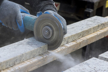 Dust while grinding close-up of worker cutting granite plate with grinder. - obrazy, fototapety, plakaty