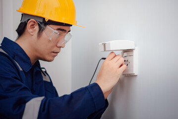 Electrician testing for voltage via multimeter.