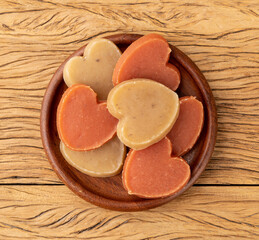 Sweet potato candy, typical brazilian june festival food over wooden table. Festa junina