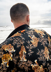 Rear view of a young male in a tiger print jacket