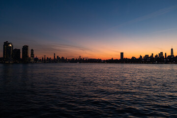 Colorful Sunset along the East River in New York City with the Williamsburg Bridge