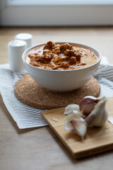 Chicken tikka masala dish bowl on a wooden table