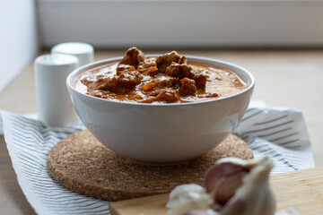 Chicken tikka masala dish bowl on a wooden table