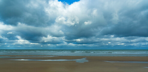 Beautiful cloudy skies over this deserted beach near the village of Vierville-sur-mer in Normandy, France