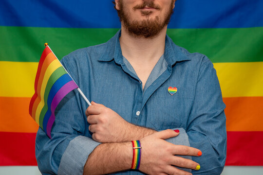 man holding lgtb rainbow flag
