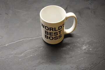 White mug with "world's best boss" text on a black surface