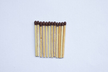 Matches in hand, fingers holding matches. Matches on the background. Unburned matches