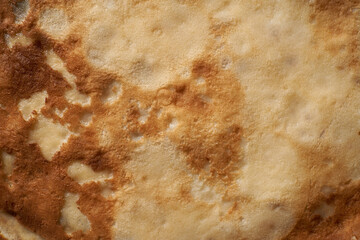 Texture of a cooked thin pancake closeup. Fried pancakes.
