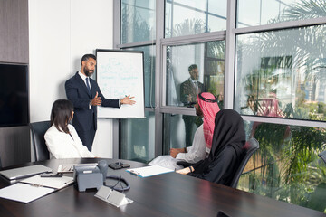 Multiethnic corporate business team meeting in the office for a strategic marketing plan - Office workers, entrepreneurs, and company employees at work in a multinational company