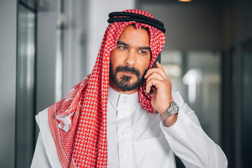 Arabian businessman making a phone call, Arabic businessman talking on the phone

