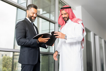 Arabian Business man with a foreign businessman discussing work in a modern office 