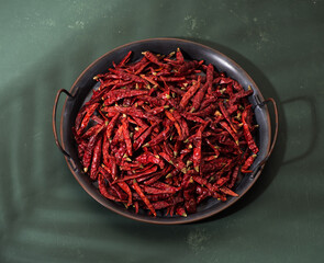 Hot chili peppers on a tray, top view