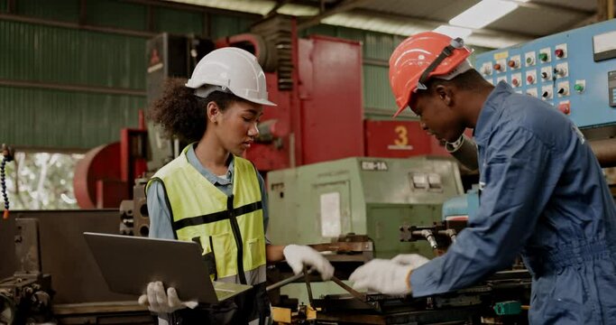Group of machine technicians are profession inspect the electrical equipment in factory. Industrial plant engineers plan machine maintenance. African American workers work with Asian team Blue collar 
