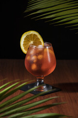 Vertical shot of a glass of Aperol Spritz cocktail on a wooden surface