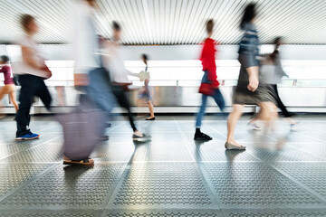 Blurred people walking on footbridge