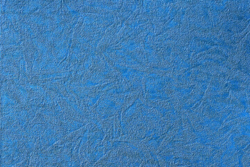 Blue background with abstract pattern of various shapes, fabric and paper texture