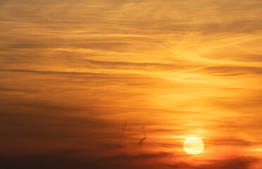 Beautiful dark golden sunset sky with clouds. Sky background.