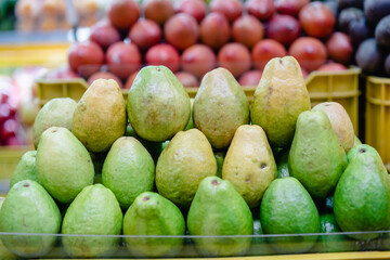typical colombian fruits stacked in market place (Guayaba)
