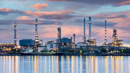 Oil and gas refinery plant area at sunrise	near sea port or river - obrazy, fototapety, plakaty