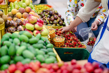 woman buying vegetables in paloquemado market square Bogota Colombia