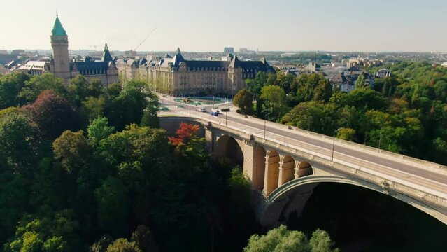 Establishing Aerial shot of Luxembourg City Panorama with Landmark Adolphe Bridge at daytime. Tourism, Travel or Urban b-roll Background. 4K drone zoom in shot