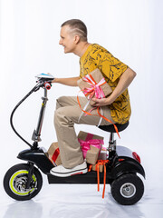 guy in an electric car. a man in the studio on a tricycle with gifts. congratulations from the man....