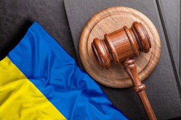 Judge's law gavel with flag of Ukraine on desk
