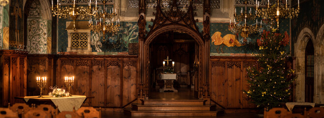 Splendid chandelier with lit candles in a beautiful room of an old mansion