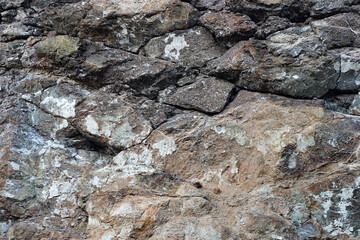 Texture of natural stone rock, background wallpaper white, gray and black splashes on the surface....
