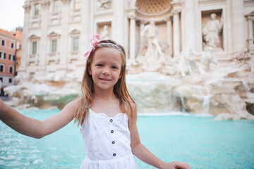 Adorable little girl background Trevi Fountain, Rome, Italy.