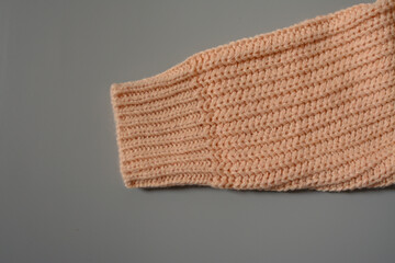 Various colors baby sweaters on dark gray background