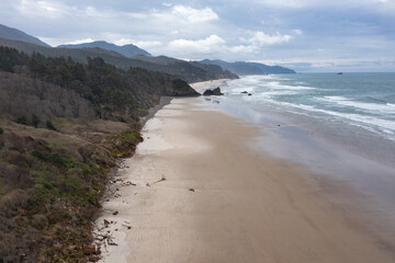 Pacific Ocean waves wash against an empty beach in Oregon, not far west of Portland. The scenic U.S. Route 101 runs right along this beautiful part of the west coast.