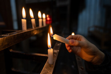 lighting a candle in a church