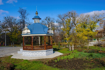 Scenic view of carved wooden romantic gazebo in public park of Okhtyrka, Ukraine