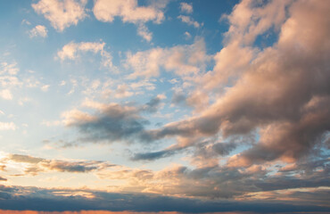 Naklejka na ściany i meble Majestic clouds burning by sunset. Sky background