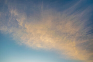 Naklejka na ściany i meble Majestic clouds burning by sunset. Sky background