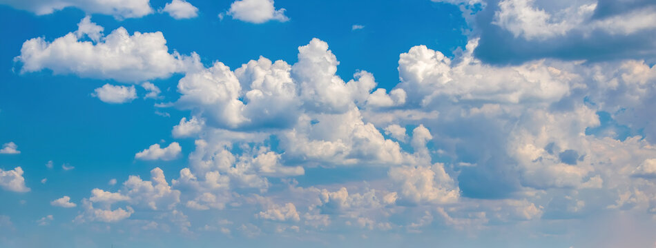 Beautiful background with picturesque white fluffy clouds in blue sky © haidamac