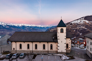 Beautiful historic church in small village at the Swiss alps during sunset, Nendaz Switzerland